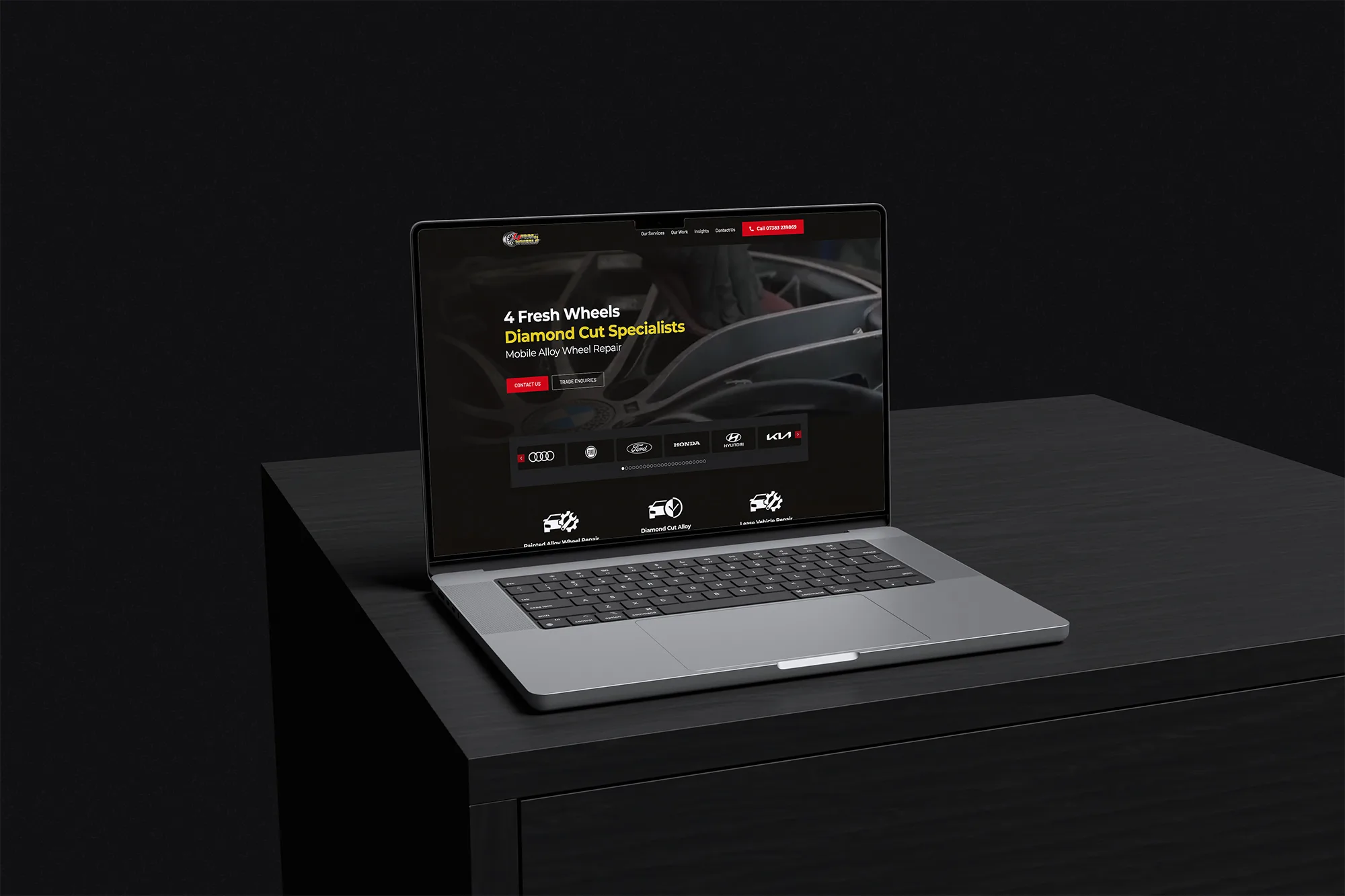 Image shows the 4 Fresh Wheels website displayed on a laptop on a cupboard in a dark room